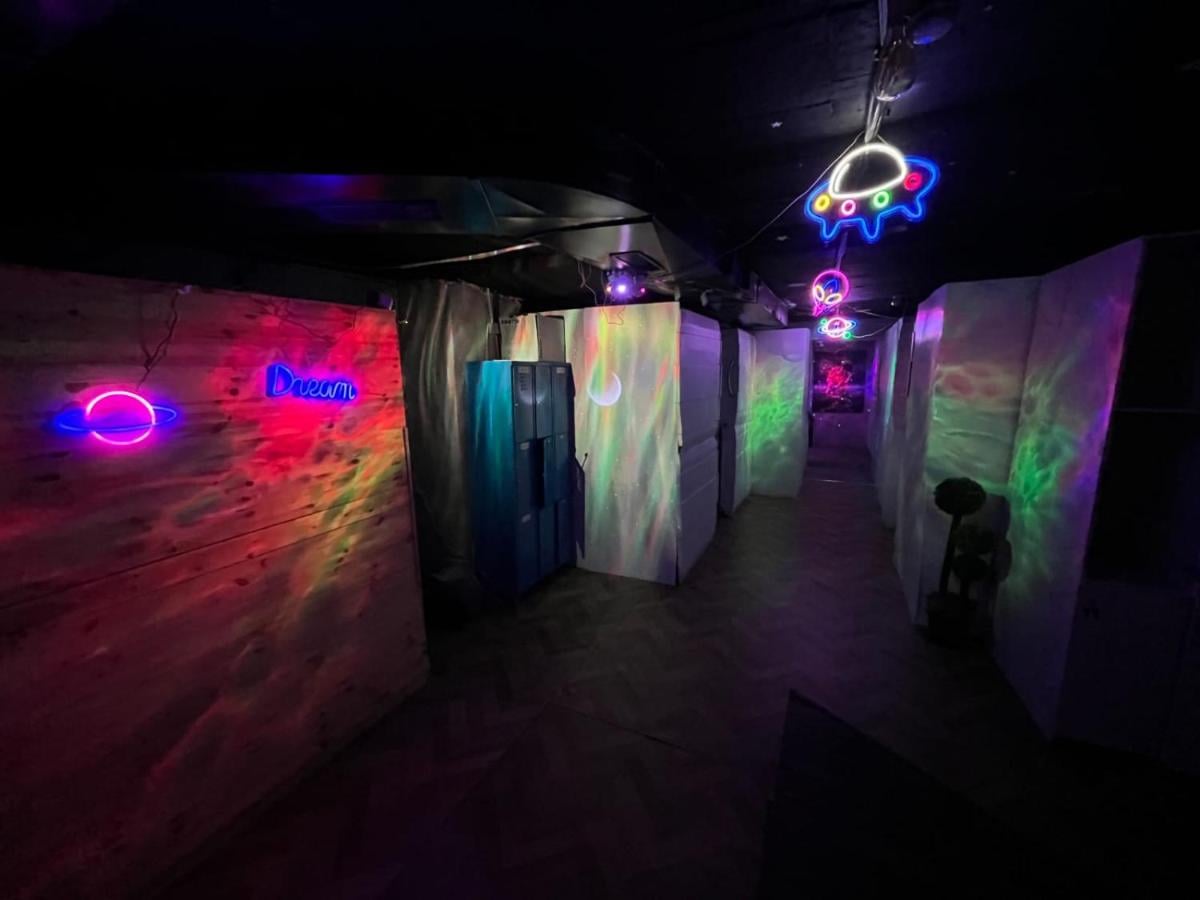 Capsule BH neon-lit corridor — futuristic capsule hotel in Jerusalem